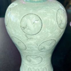 Korean celadon vase featuring a signature jade green glaze and an inlaid crane and cloud moti