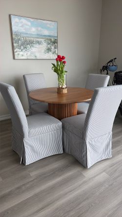 Wooden circle table and four blue and white striped chairs