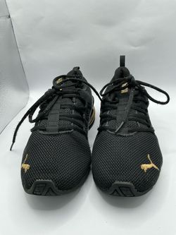 Women’ Puma Black and Gold Sneakers size 7