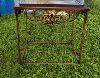 vintage wrought iron and glass console table,  copper finish, featuring ornate scrollwork. 