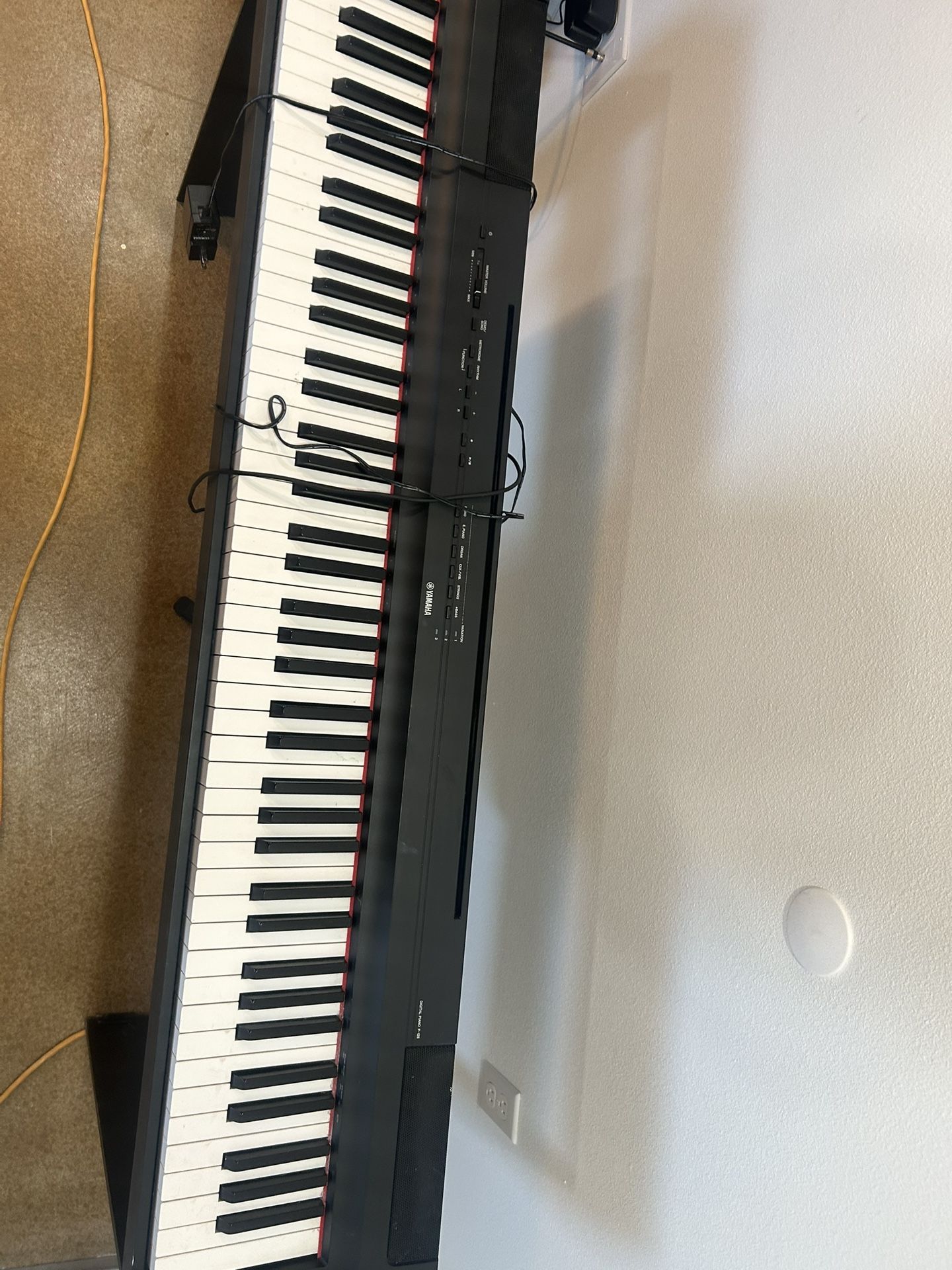 Yamaha Piano with a Chair 