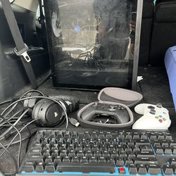 Monitor , Headphones, Keyboard And Two Xbox Controllers.