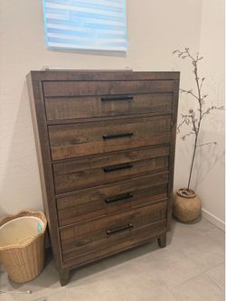 2 brown tall dressers