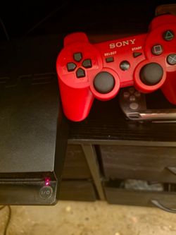 PlayStation 3 Slim Console with hen and Red DualShock 3 Controller