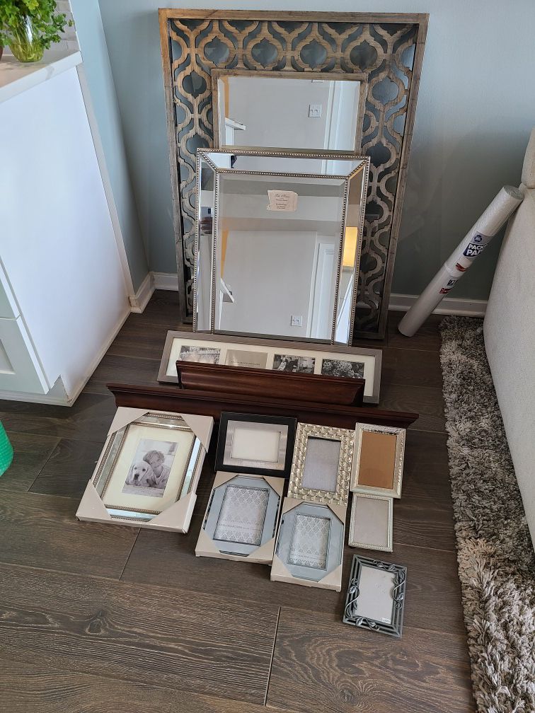 Various mirrors, wall mounted shelves, and picture frames