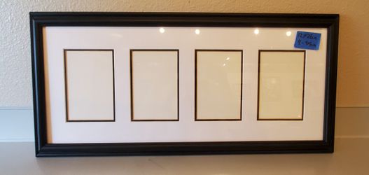 black frame with white matting 4- 4x6 openings