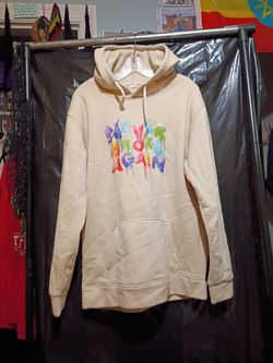 Cream colored pullover hoodie featuring a colorful " Never Broke Again" dripping graphic on the chest. Size XL.