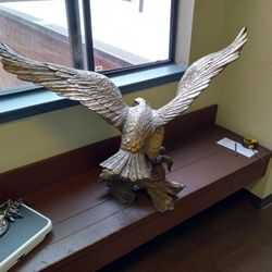 Solid brass eagle on solid bronze log