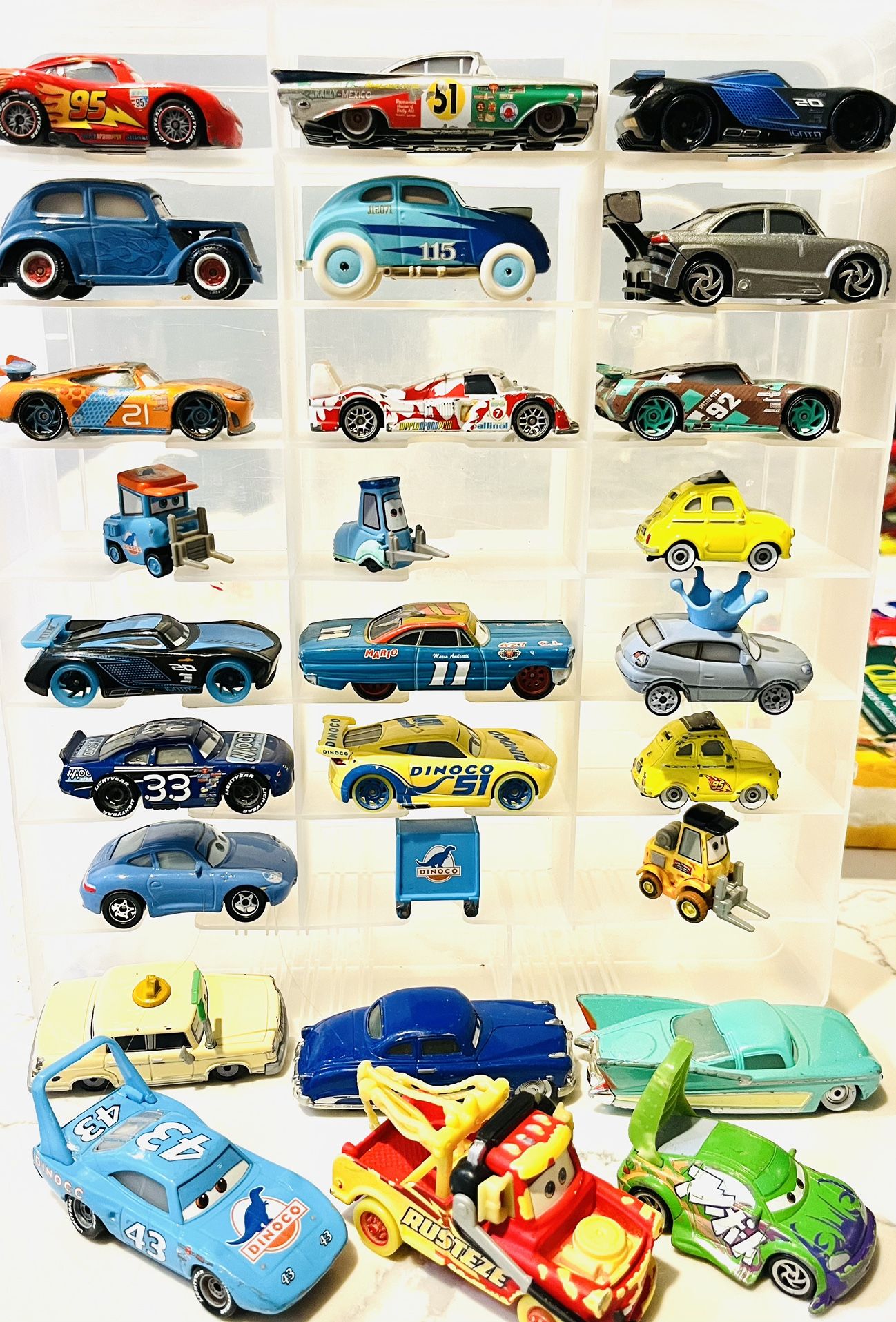collection of die-cast toy cars from the Disney and Pixar Cars franchise. These vehicles are highly detailed, 1:55 scale models designed to replicate