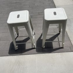 Two metal counter height bar stools