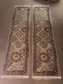 Two matching floral patterned rugs/runners with fringe.