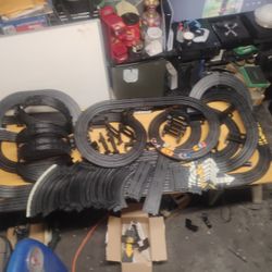 Two Slot Car  Sets  And An Expansion Pack With Over 100' Of Track 