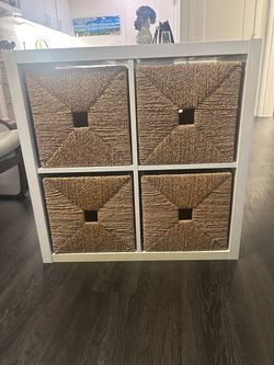 IKEA KALLAX 2x2 shelving unit with 4 woven storage baskets.