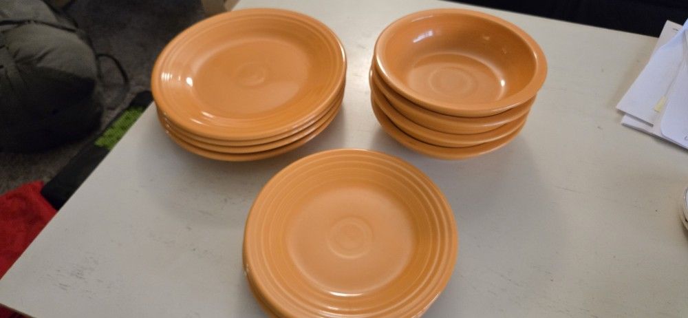11 piece fiestaware Orange dinner plate, salad plates bowls