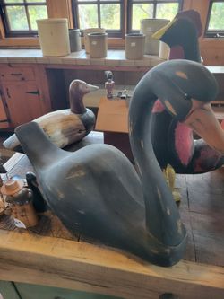A vintage hand-carved wooden swan decoy