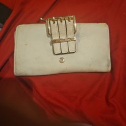 Used Michael Kors beige Wallet.  Has Many Cardholders And Zipper Pouch For Coins And Cash Slot