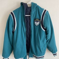 This is a reversible hooded baseball jacket (pilot jacket style). • Reversible design: One side is made of teal fleece, while the other side is navy b