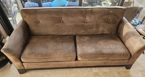 Transitional style sofa in a Brown, with suede fabric. 