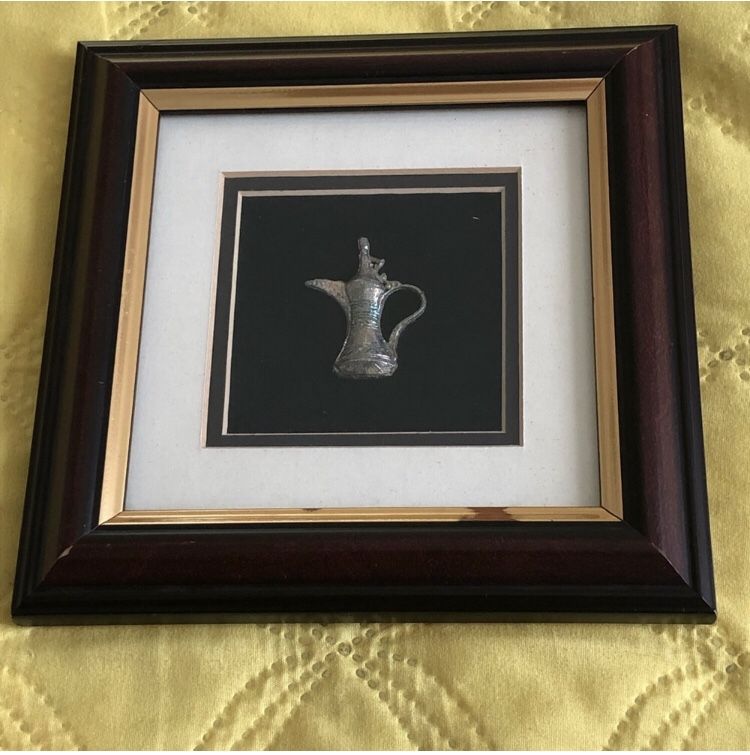 Frame with a "dallah"/Arabic Coffee pot inside it.