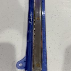 Blue Swingline adjustable 3-hole punch with a built-in ruler, made of transparent blue plastic with a metal punching mechanism