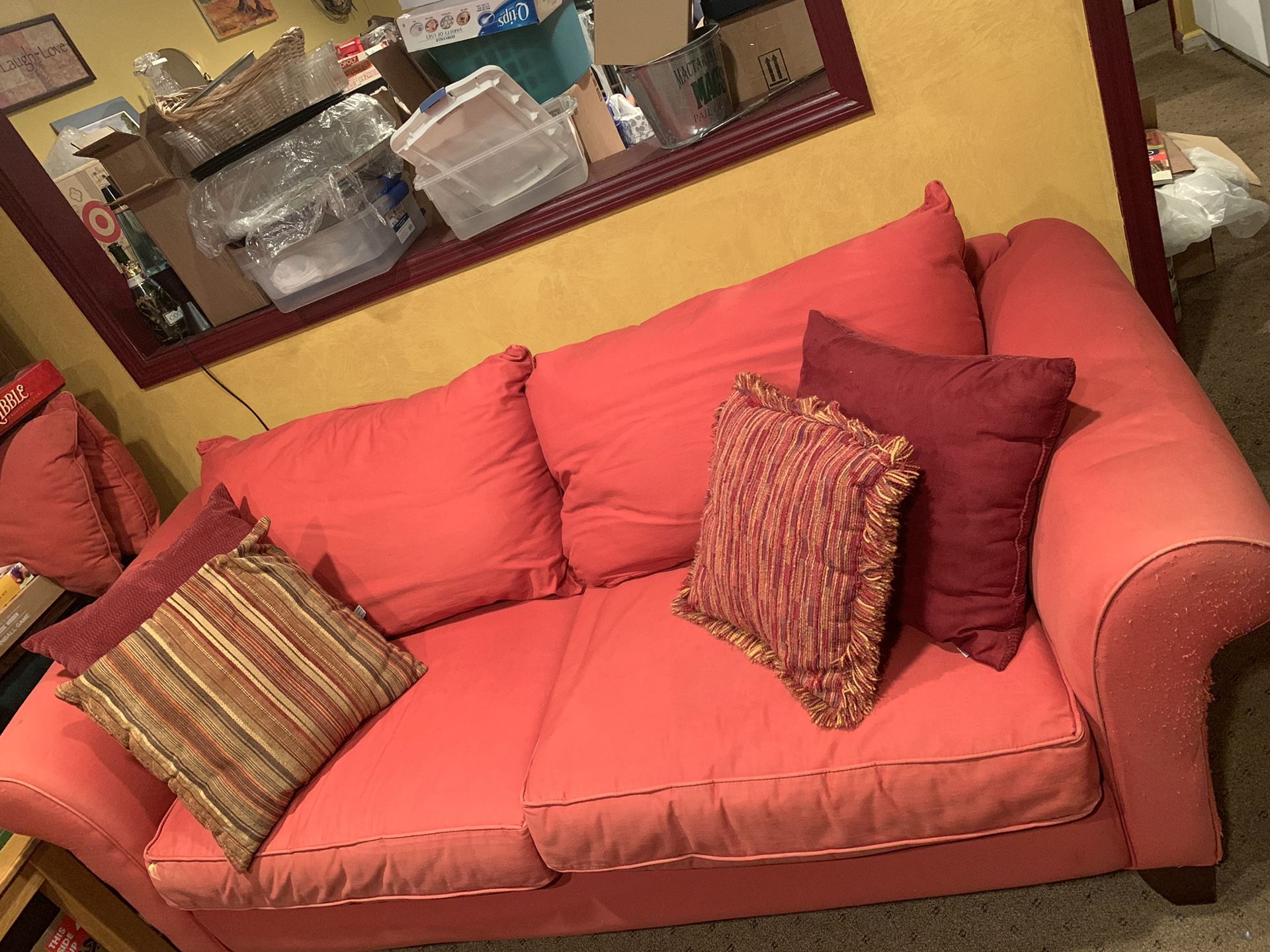 red couch with pillows and slipcover