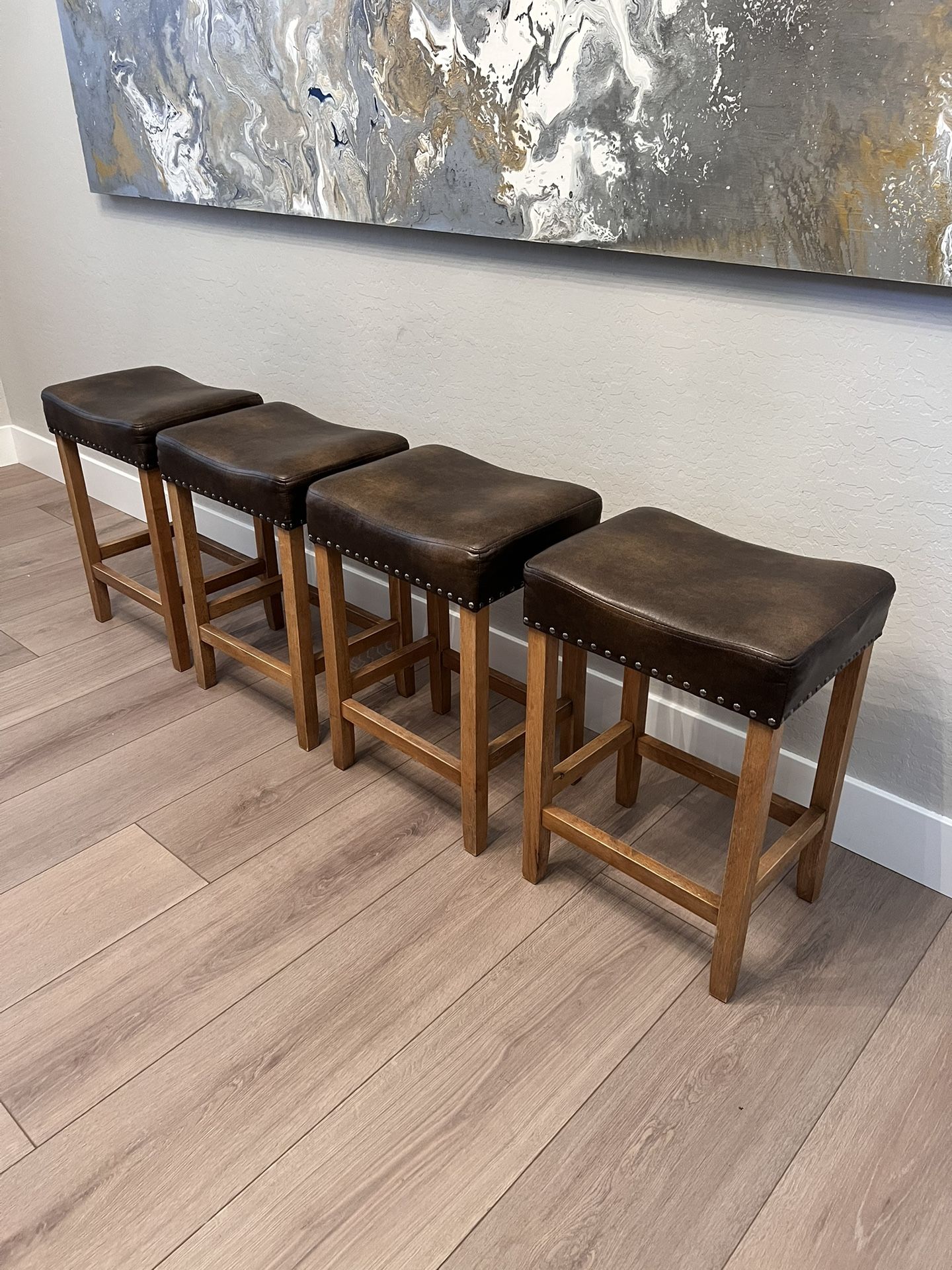 FOUR 24” Counter Height Saddle Bar Stools w/ Curved Seats And Nailhead Pin Design