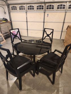 Black solid wood table with glass top and custom cushions