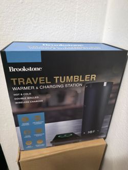 Travel tumbler with heating pad and charging station for phone