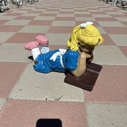 New girl reading made out of cement