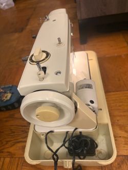 This appears to be a vintage portable sewing machine, resembling a mid-century Sears Kenmore or similar Japanese-manufactured portable sewing machine 