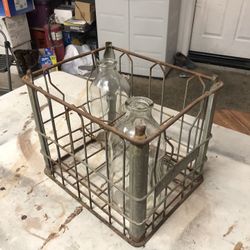 Vintage milk crate with two vintage bottles