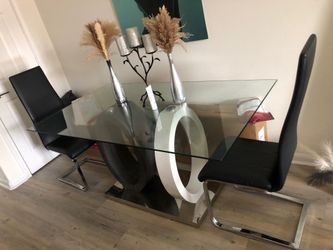 Large crystal dining table that can fit six chairs.