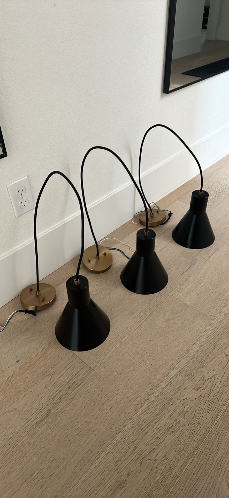 3 black and brass pendant lights
