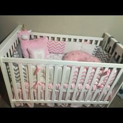 Girl crib rail liner, the fitted sheet, and the comforter on top