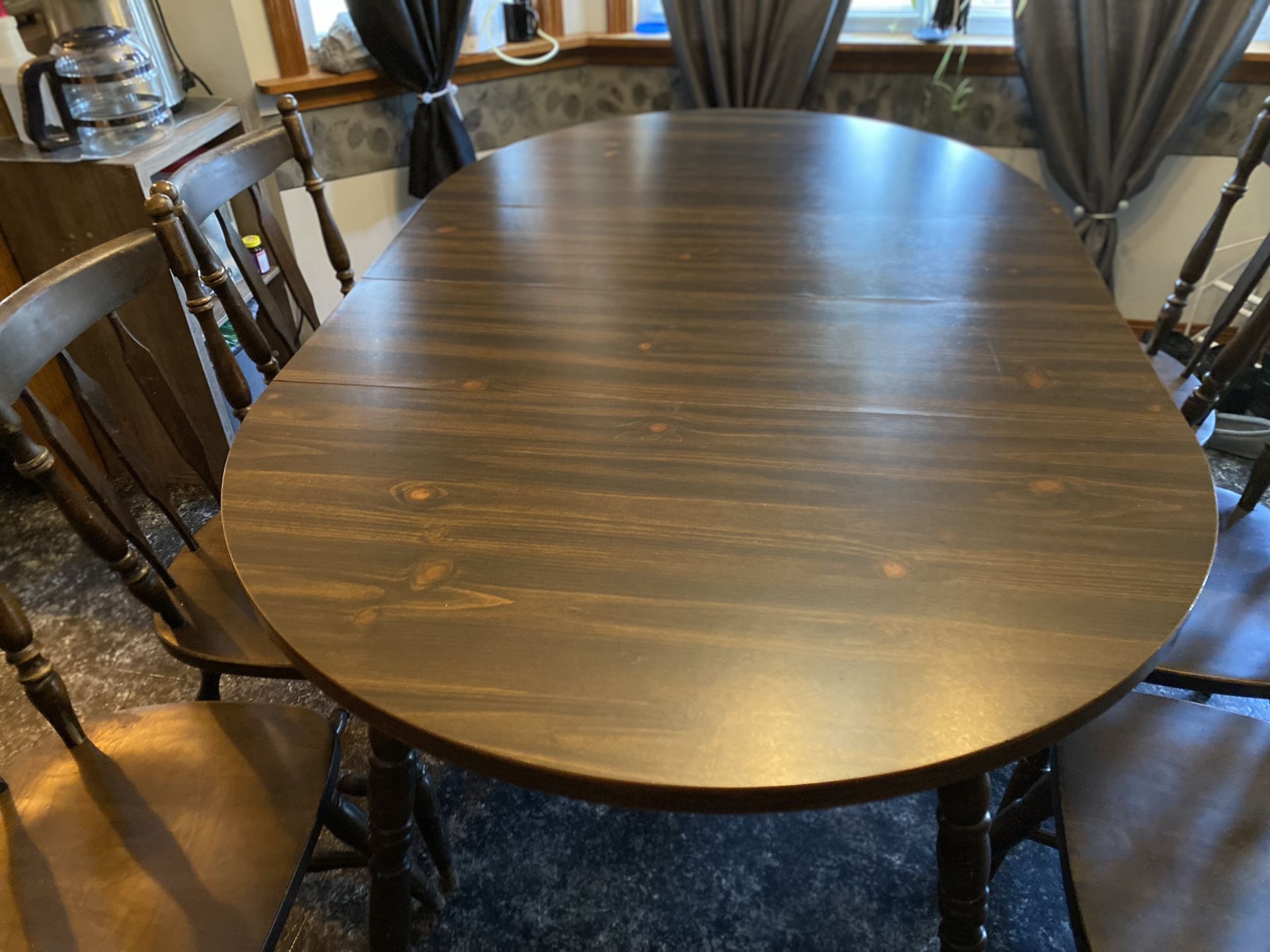 Solid wood Formica top older table and 6 chairs Approximately 66x42 with both leaves in it