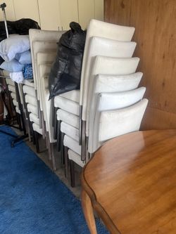 stackable upholstered dining/party chairs (looks like faux leather with metal legs) —