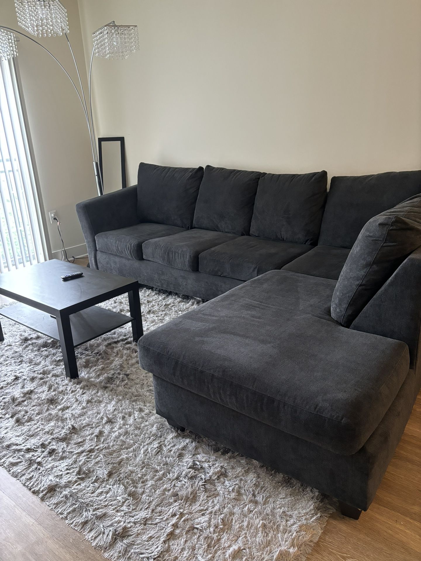 Black Sectional With Gray Fur Rug 