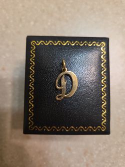 14 k gold letter D pendant.  Weight is 1.2 grams