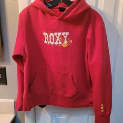 vintage Roxy red hooded sweatshirt with a kangaroo pouch pocket and "ART OF SURFING" graphic text. 
