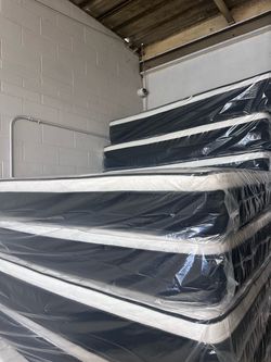 New Mattresses Still in Plastic Wrap