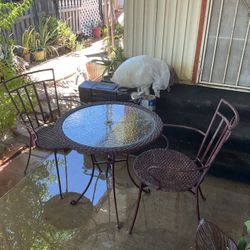 Glass Table With Two Metal Chairs 
