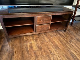 Dark wood TV stand with drawers