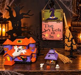 Vintage Halloween decor set with two candle holders: a jack-o’-lantern votive cover and a ceramic spooky tree scene holder. Both come in their origina