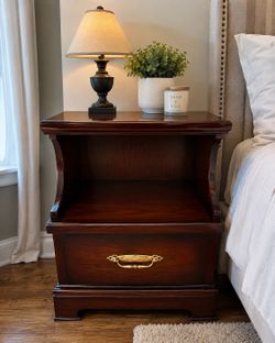 Dark wood nightstand with drawer and open shelf