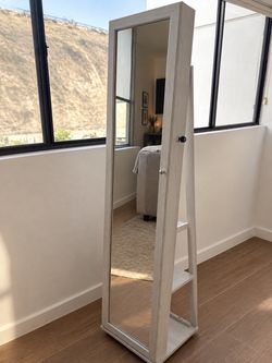 Mirror with jewelry storage