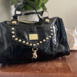 Black and gold Betseyville purse. Some of the metal areas have tarninshed