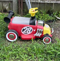 Kids riding toy car.