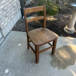 Child sized oak chair fits adults as well with two-slat horizontal backrest & contoured wooden seat