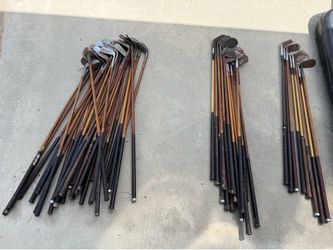 Pile of old wooden golf clubs