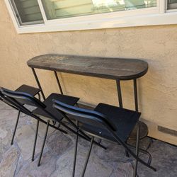 Three Bar Stools And A Table